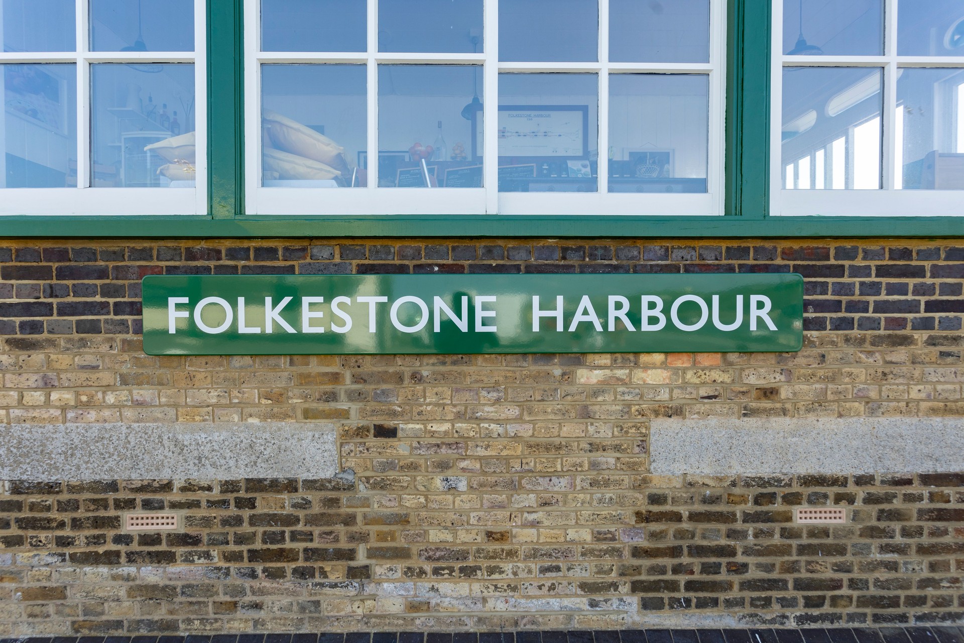 Folkestone harbor sign on green